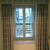 Achieving a total blackout effect with a combination of shutters and curtains.