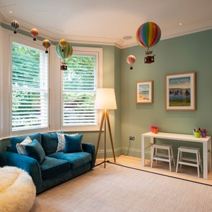 Shutters in living room green walls