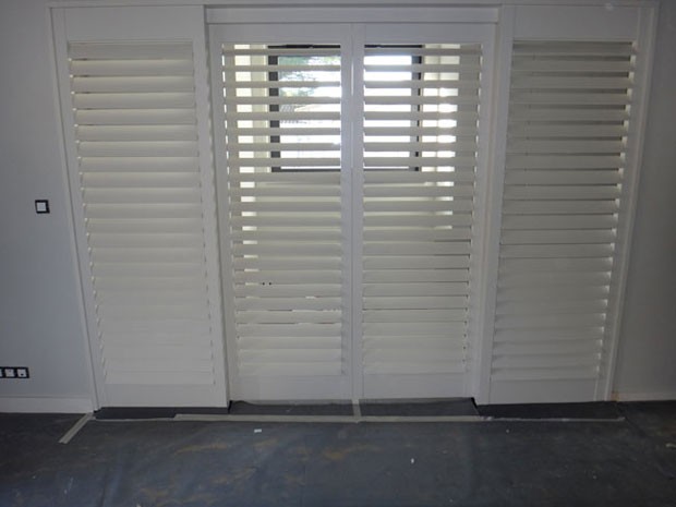 White painted tulipwood shutters