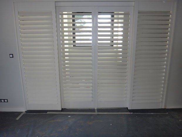 White painted tulipwood shutters